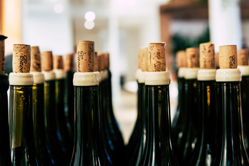 Rows of corked wine bottles.