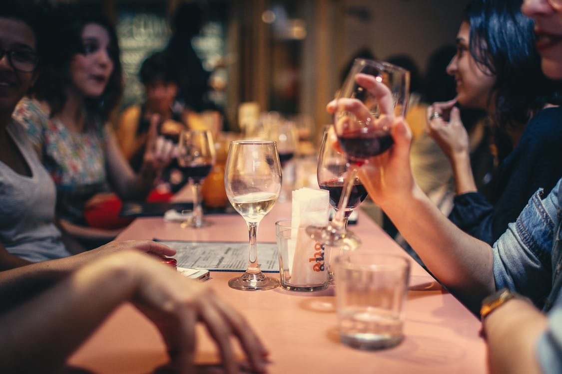 Close-up shot of people drinking wine