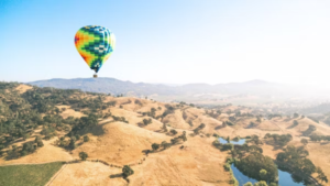 A hot air balloon floats over Napa’s skyline.